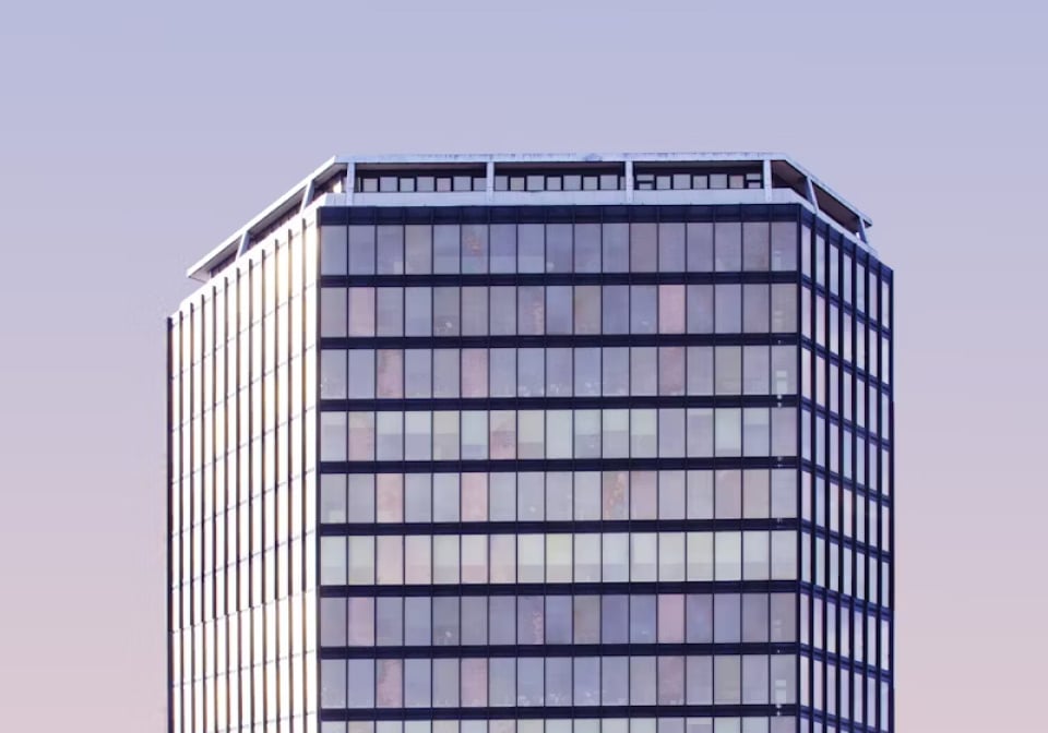 picture of an office, with a few people working at desks