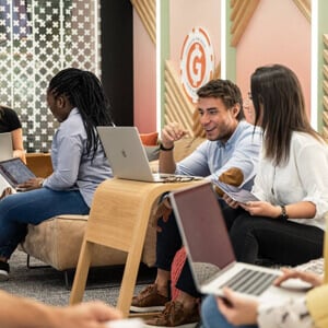 Young business professionals looking at laptop