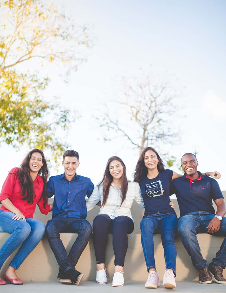 Group of students posing for a picture in the park